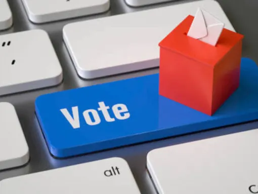 Image of a computer keyboard with a blue button that says "Vote."